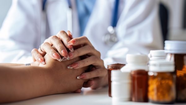 doctor-touching-patient-hand-counsel